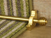Sphere stair rods polished brass on green striped runner